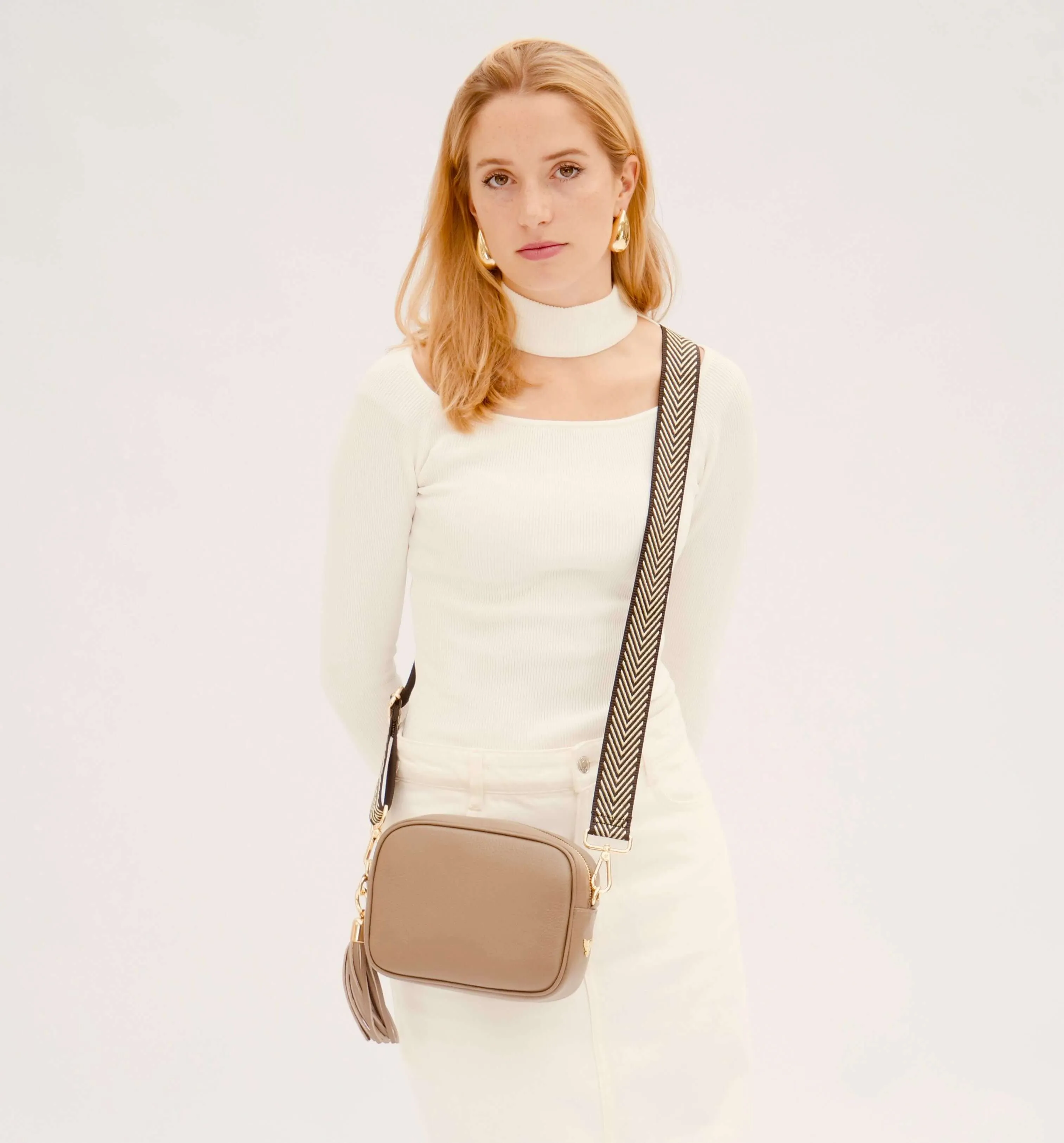 The Tassel Latte Leather Crossbody Bag With Black & Gold Chevron Strap